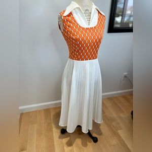 Vintage dress with pleated skirt, eccentric collar, and zipper in the back.